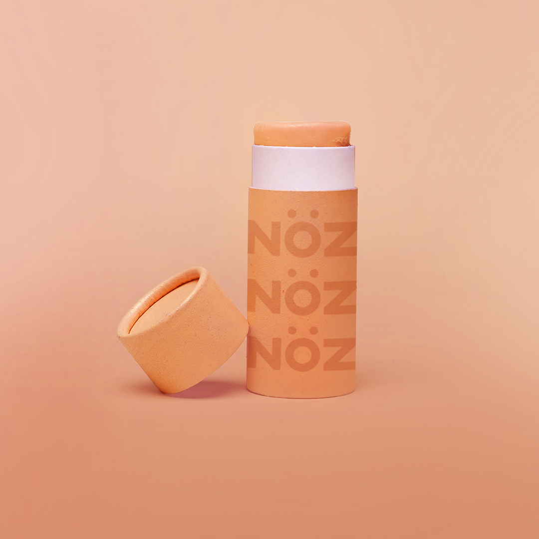 Stick of orange noz sunscreen without cap