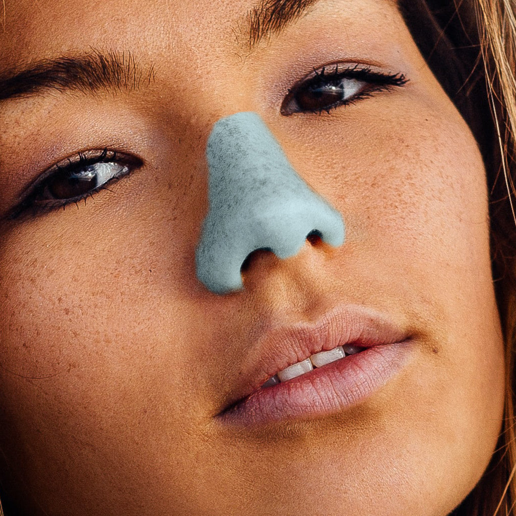 Girl with brown hair wearing blue nozscreen on her nose